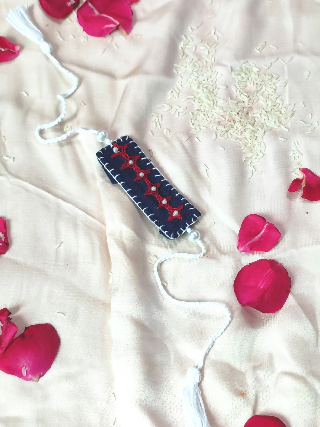 Blue handmade rakhiwith hand embridery and bead details for your naughty bro