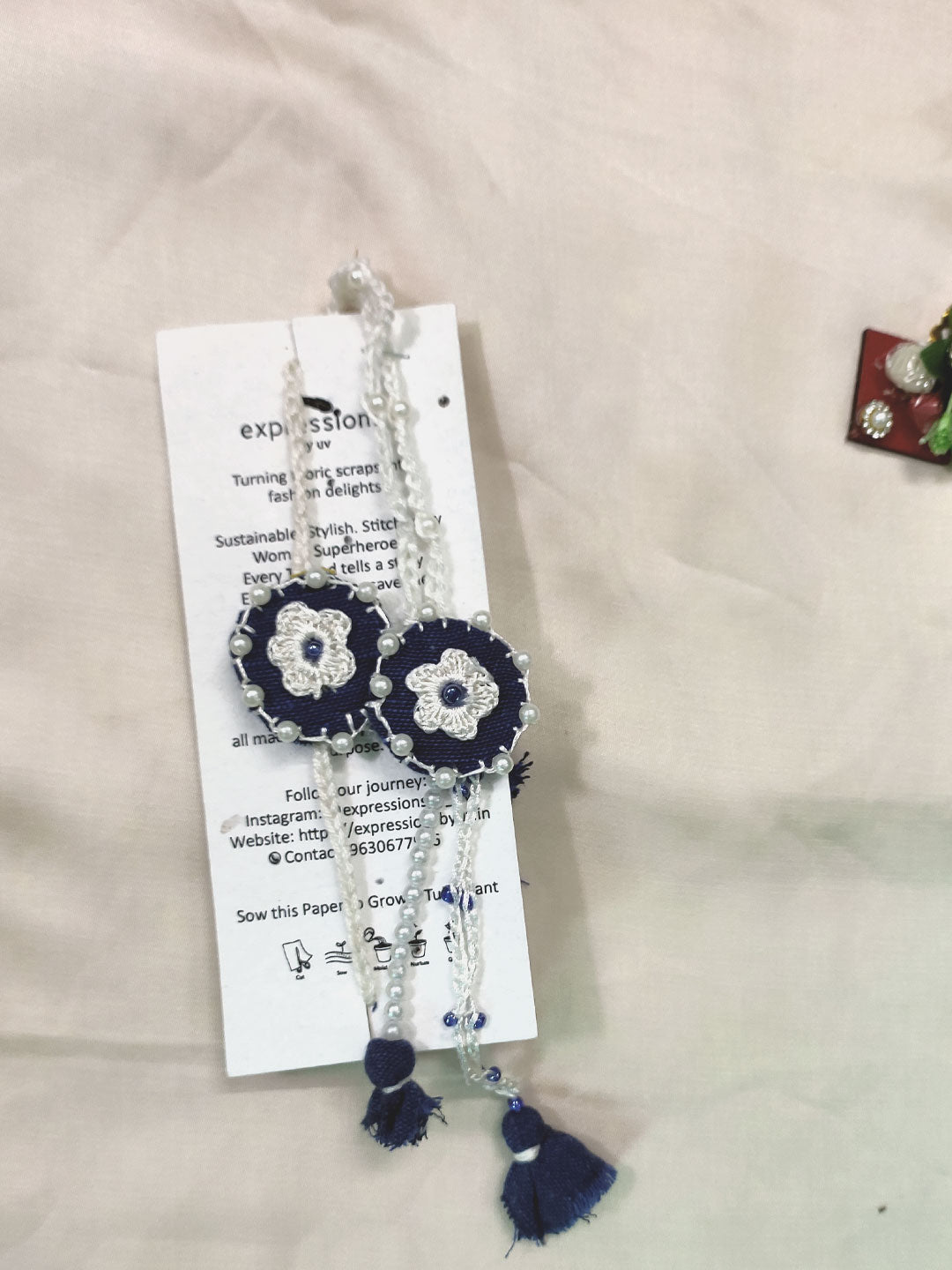 Navy ivory akhi lumba set for your favourite bhai bhabhi  and it comes with a tulsi seed tags as some bonds needs to grow ever after