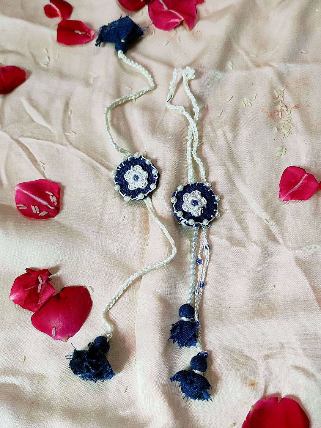 Navy ivory couple rakhi, handcrafted with crochet , bead work details and upcycled from fabric scrapes. comes with tulsi seed tag !